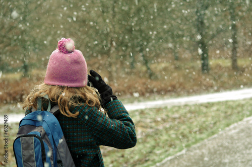 Girl taking photos of the snow