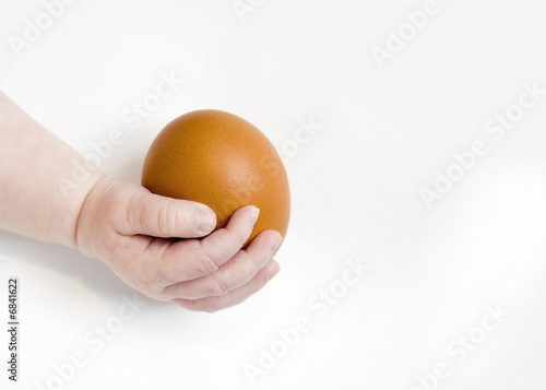 Baby holding egg