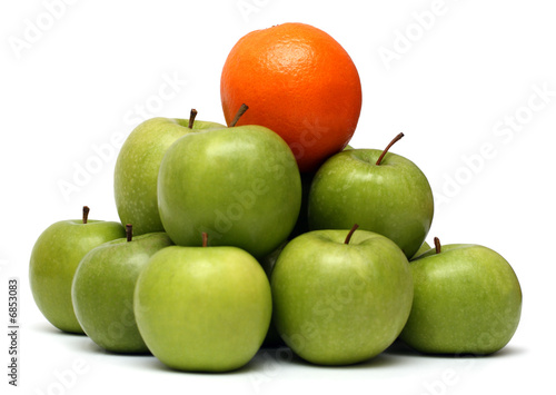 domination concepts - orange on pyramyd of apples photo