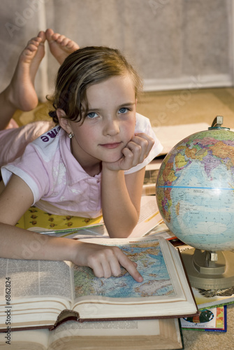 Girl with globe on sunlight