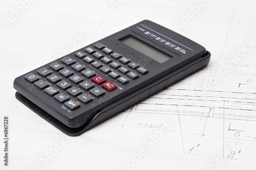 Calculator on engineering design drawing background
