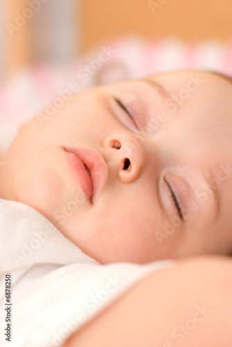 sweet baby sleeping on a blanket closeup