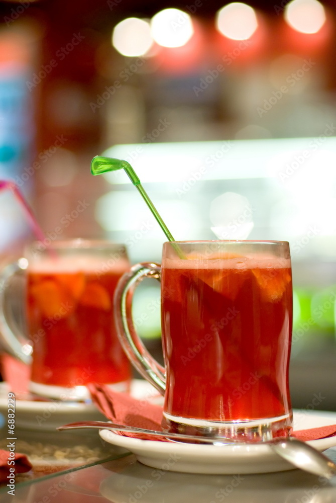 Cup of fruit tea on abstract blurred background (shallow DoF) Cup of fruit tea on abstract blurred background (shallow DoF)