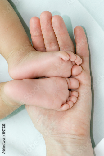 Children's legs on a parent hand