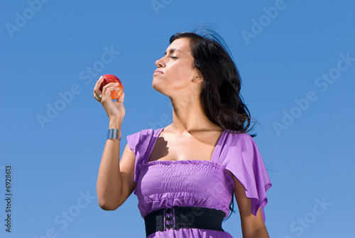  The girl with an apple against the sky