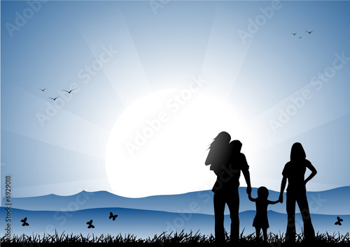 Family at sunset in a meadow