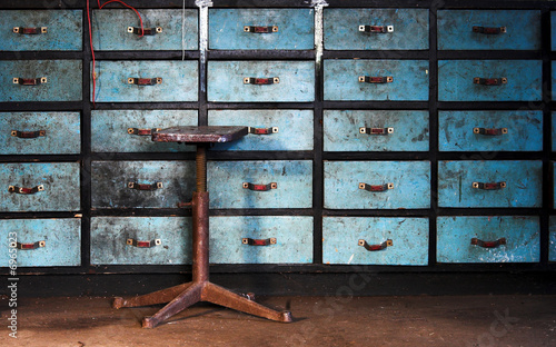 Old stool on drawers background