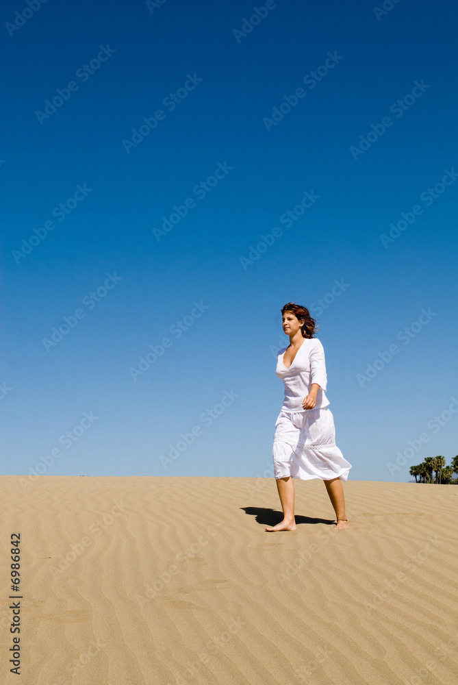 Beautiful woman walking in the sand Beautiful woman walking in the sand