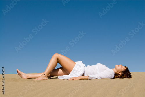 Woman lying in the sand