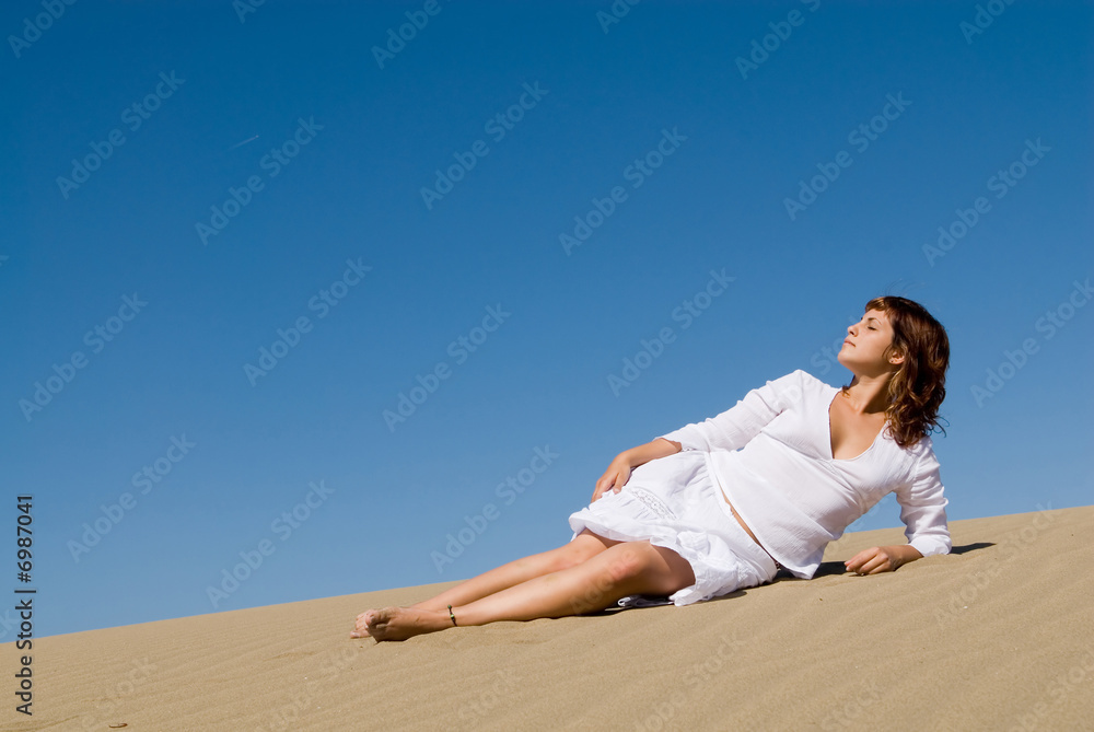 Beautful woman lying in the sand