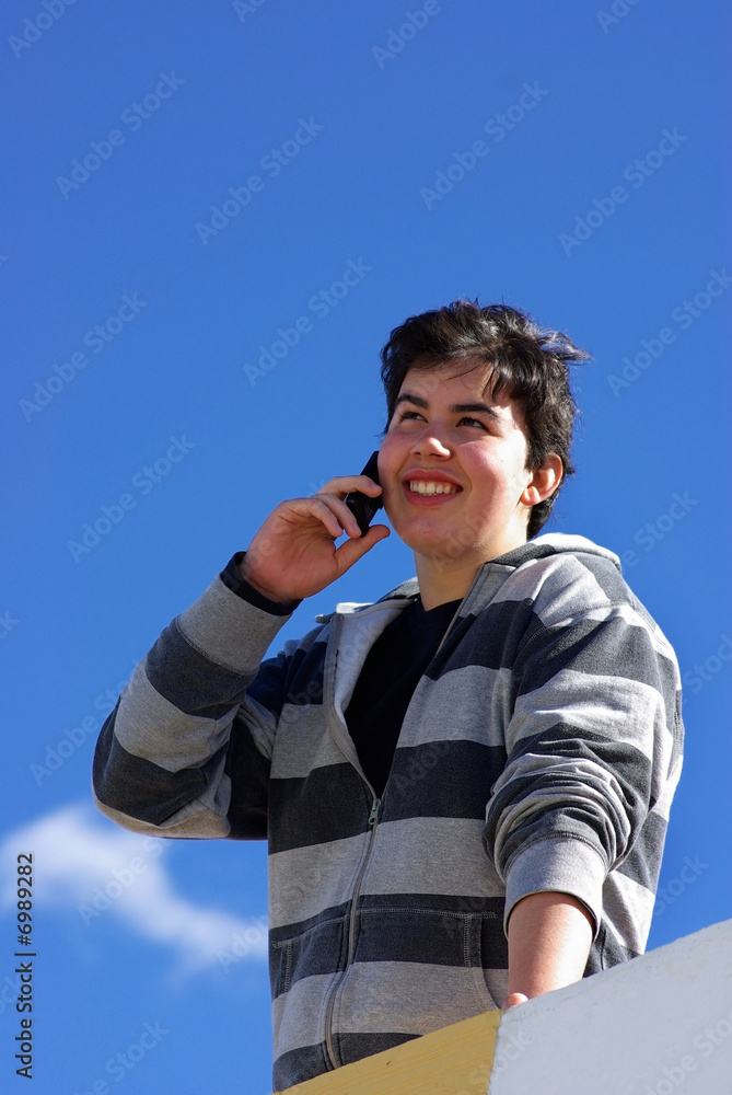 Happy  youngster speaks to the mobile telephone.