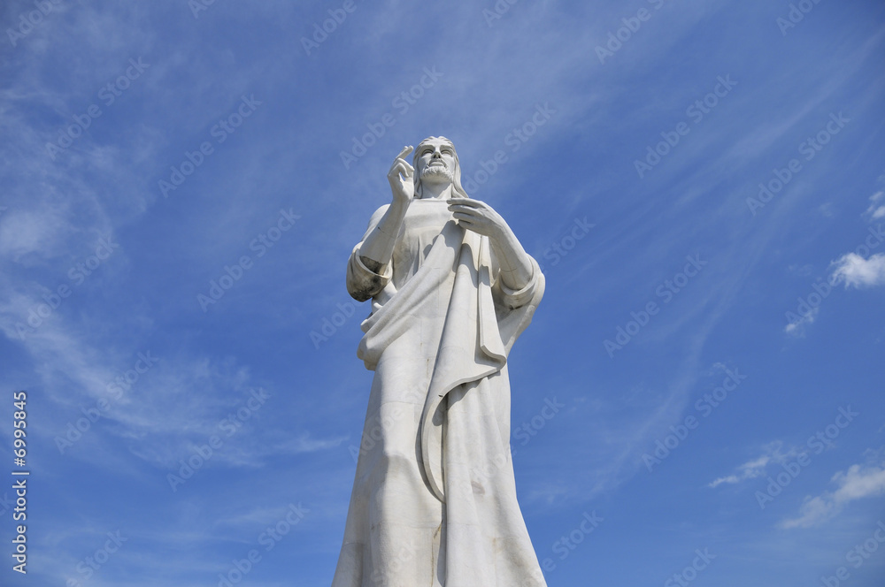 Statue of jesus christ against blue sky
