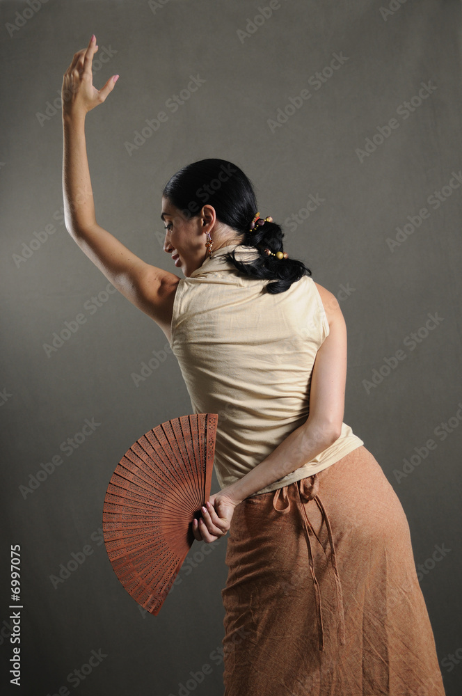 Fototapeta premium hispanic flamenco dancer in traditional pose with fan