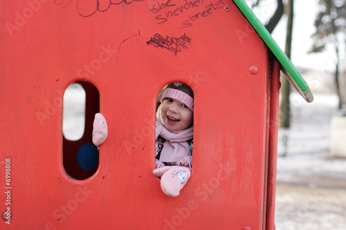 Canvas Print little girl play hide-and-seek at the kindergathen playground