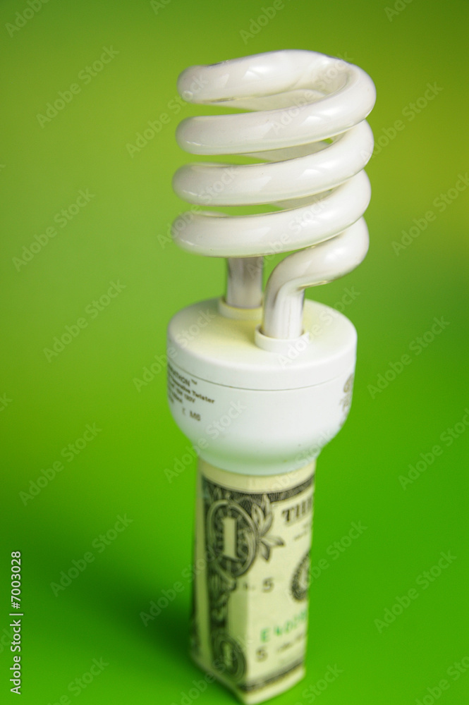 Compact fluorescent light bulb, in a dollar bill Compact fluorescent light bulb, in a dollar bill