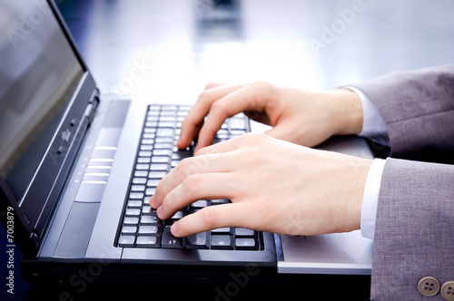 Businessman's hands on notebook keyboard