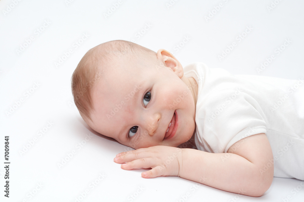 Smiling baby lying on the floor Smiling baby lying on the floor