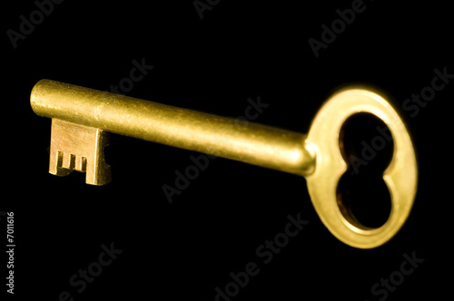 Golden key isolated on black background