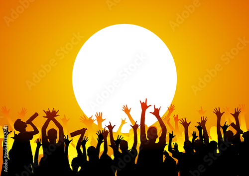 Happy people on holiday at sunset