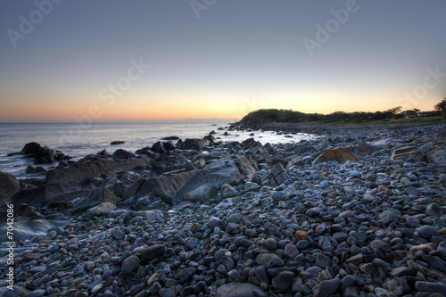 Summer sunrise of a pebble beach