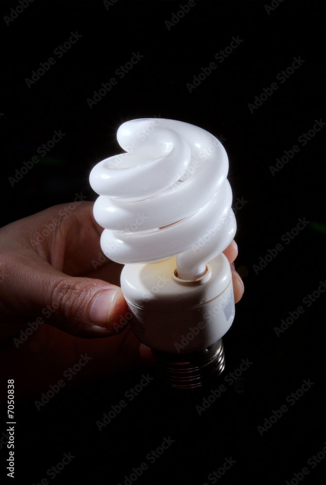 Human hand holding cfl lightbulb Human hand holding cfl lightbulb