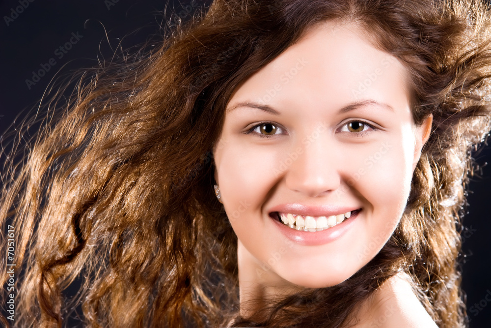 Young smiling woman with long brunette hair