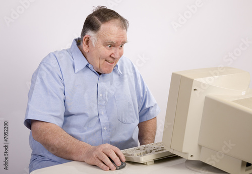 Old guy at computer grinning