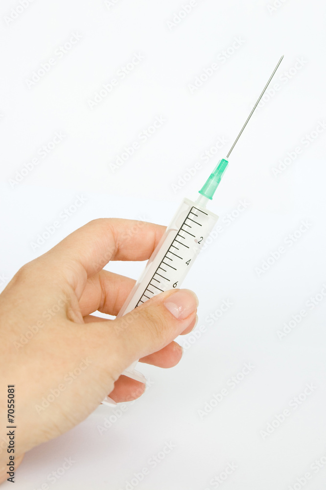 Hand holding a disposable syringe isolated on white background