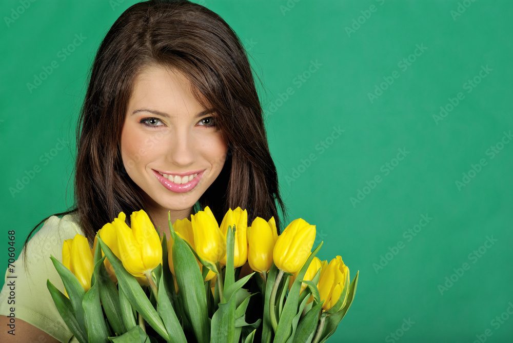 Smiling girl with summer flowers on green background Smiling girl with summer flowers on green background