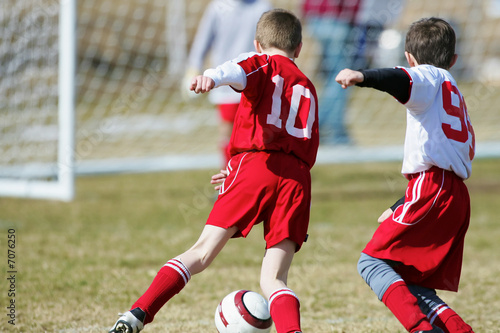 Soccer boys competing for a goal