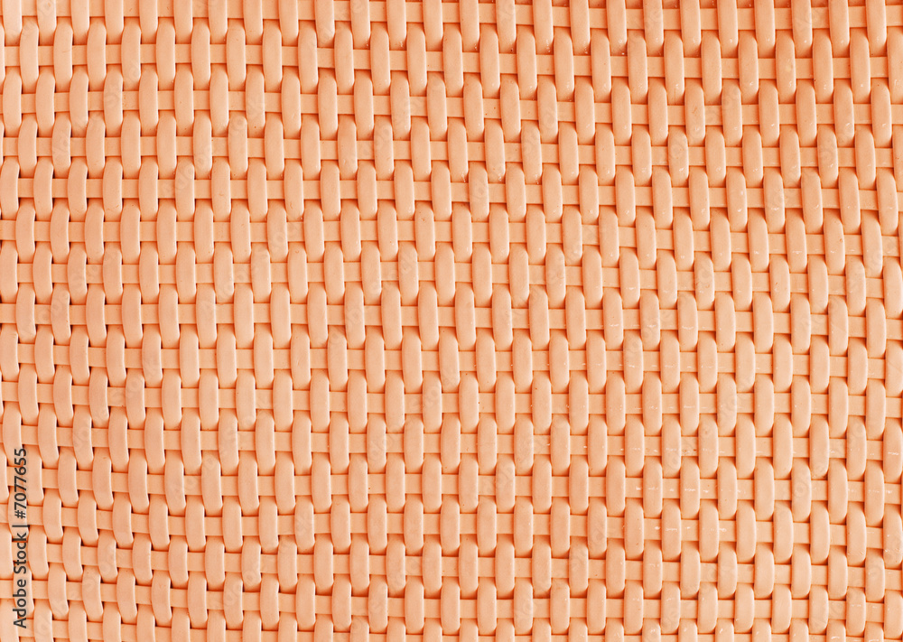 Background made of woven reddish plastic stripes Background made of woven reddish plastic stripes