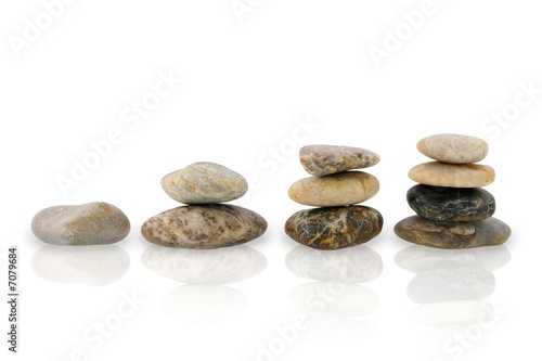 Four stairs of stones representing growth, isolated on white