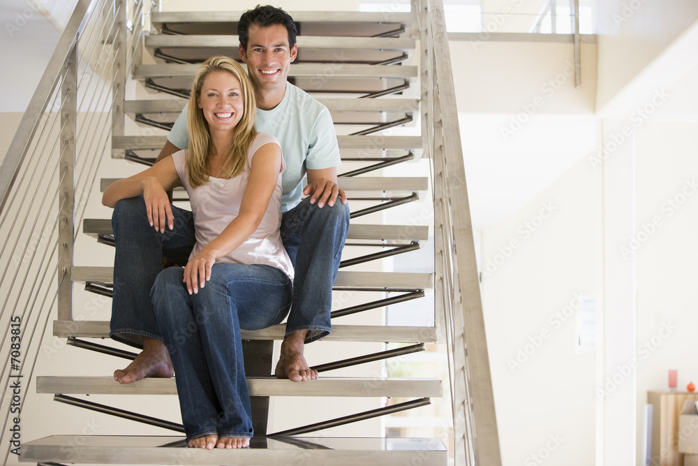 Couple at home sitting on stairs