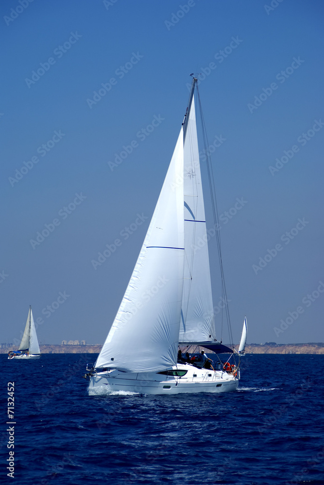 Cruising yachts in mediterranean sea on bluesky background