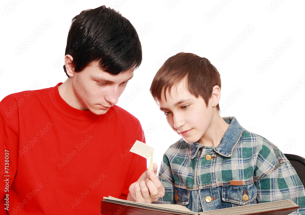 Brothers examine a stamp