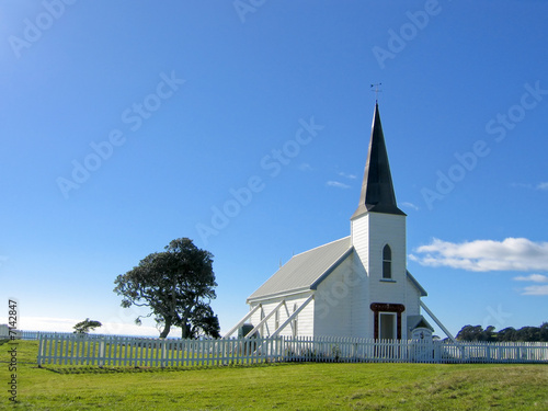 small white wooden protestant church with a blue sky photo