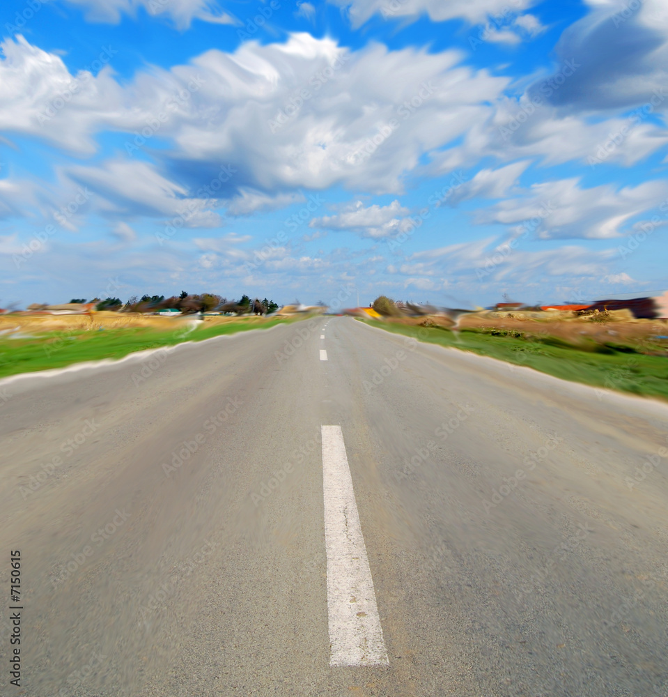 Road and blue sky with clouds in motion