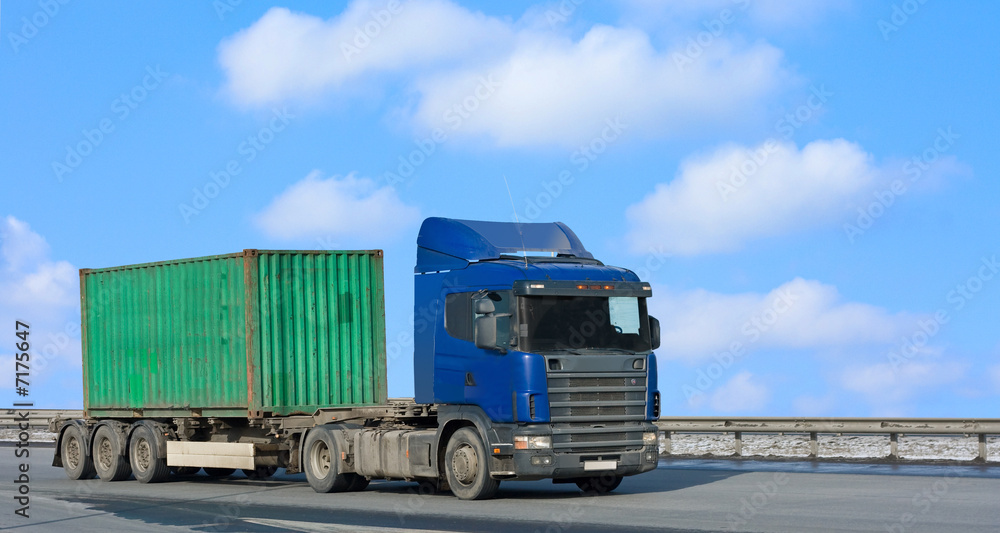blue truck moves green container blue truck moves green container