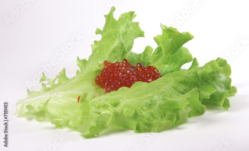 Red caviar on the lettuse leaf photo