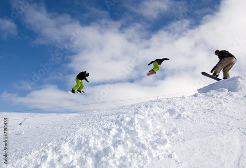 Snowboarders Jumping
