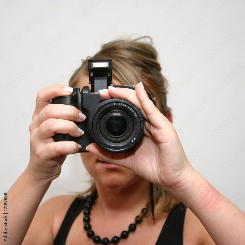 Young woman looking through her digital camera Young woman looking through her digital camera