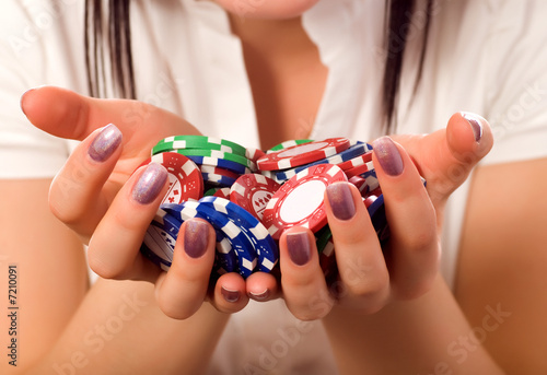 Принти на полотні girls hands holding a bunch of poker chips (focus on front)