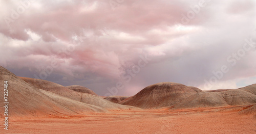 Sand dunes under a dramatic sky near Monument Valley