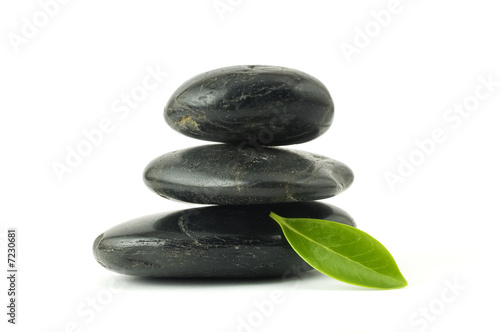 Pebbles stack and green leaf
