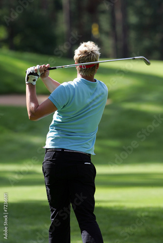 Golfer strikes a tee shot