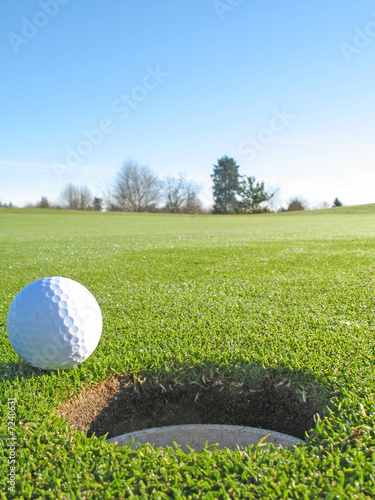 golf ball beside hole