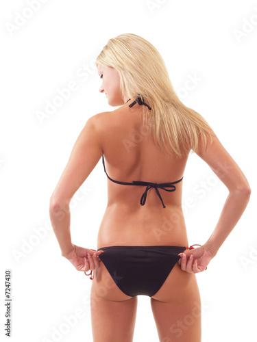 Young blond woman in black bikini from back