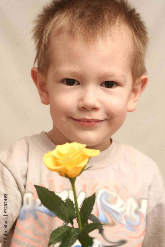 The nice boy with a rose in a hand