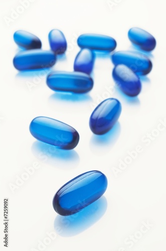 Blue capsules on white background