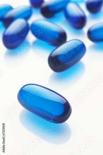 Blue capsules on white background